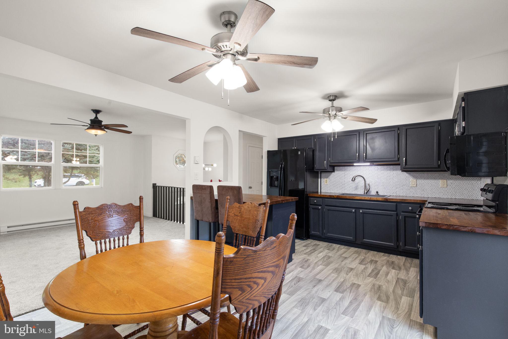 148 Sharon Street Rising Sun, MD 21911 - Photo 15 of 43 a large kitchen with kitchen island a stove a sink a dining table and chairs