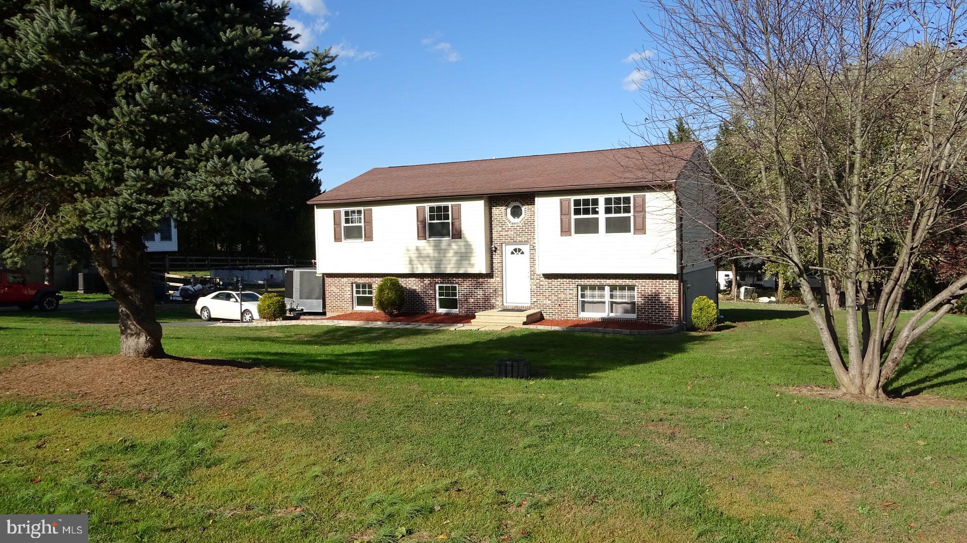 148 Sharon Street Rising Sun, MD 21911 - Photo 3 of 43 a front view of a house with a garden and trees