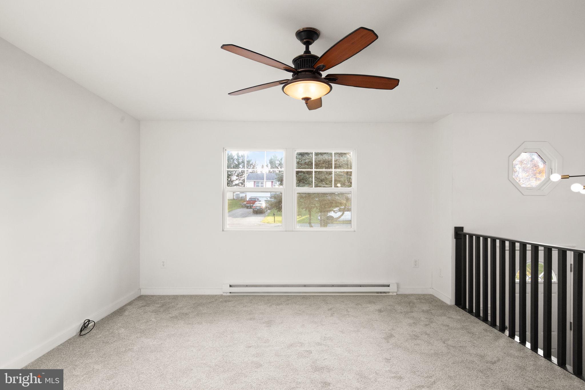 148 Sharon Street Rising Sun, MD 21911 - Photo 8 of 43 an empty room with wooden floor and windows
