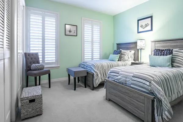 a bedroom with two beds and a window
