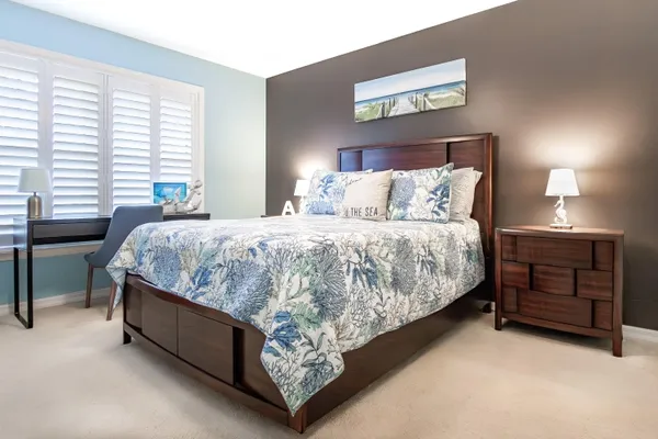 a bed sitting in a bedroom next to a window