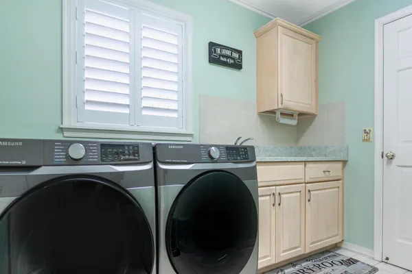 a utility room with sink dryer and washer