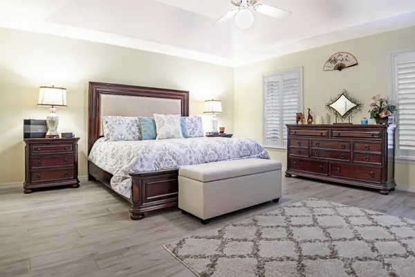 a bedroom with a bed and a dresser in it