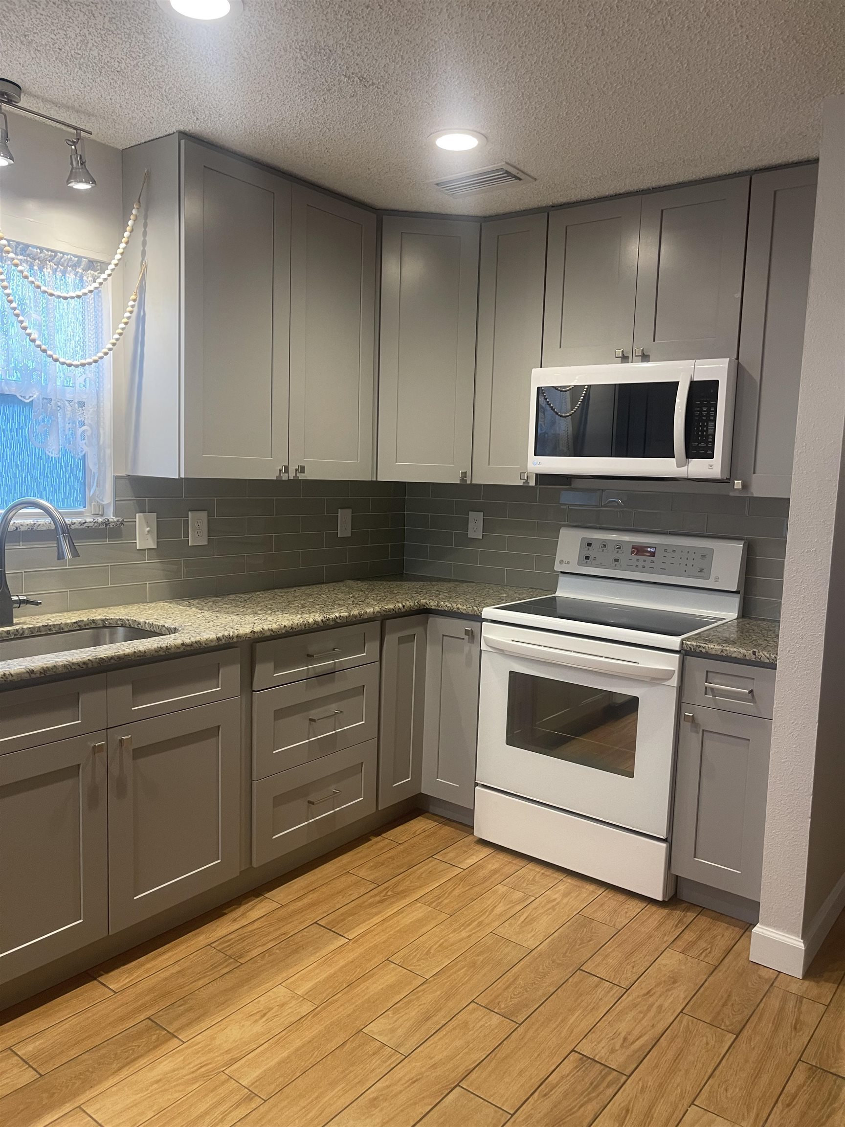 2928 Del Rio Drive St. Augustine, FL 32084 - Photo 3 of 18 a kitchen with granite countertop a sink cabinets and stainless steel appliances