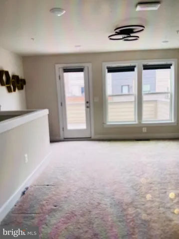 an empty room with a window and wooden floor