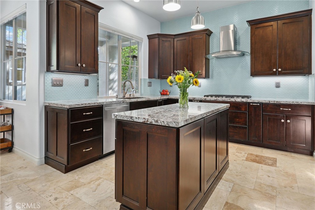 7 Wegeford Circle Ladera Ranch, CA 92694 - Photo 16 of 74 a kitchen with stainless steel appliances granite countertop a stove a refrigerator and a wooden cabinets