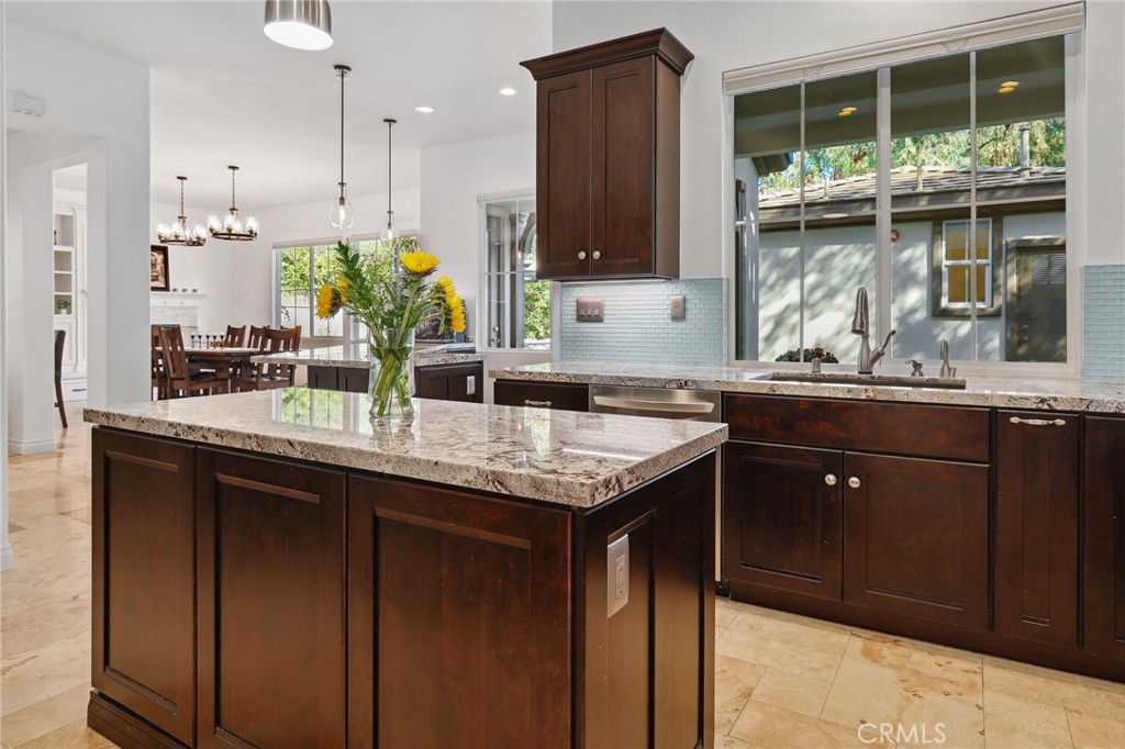 7 Wegeford Circle Ladera Ranch, CA 92694 - Photo 17 of 74 a kitchen with granite countertop a sink and a wooden cabinets