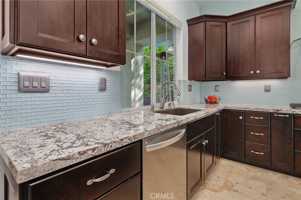 7 Wegeford Circle Ladera Ranch, CA 92694 - Photo 19 of 74 a kitchen with granite countertop cabinets and window