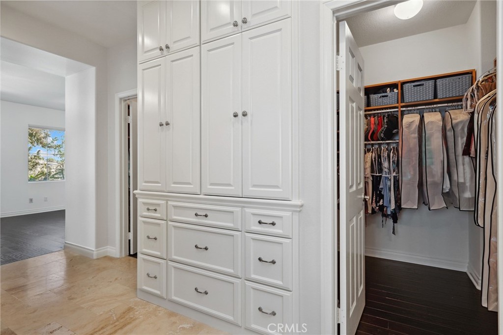 7 Wegeford Circle Ladera Ranch, CA 92694 - Photo 29 of 74 a view of walk in closet with clothes and shoes