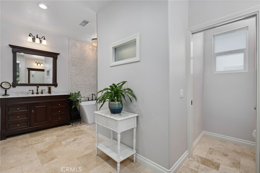 7 Wegeford Circle Ladera Ranch, CA 92694 - Photo 31 of 74 a spacious bathroom with a granite countertop sink and a mirror