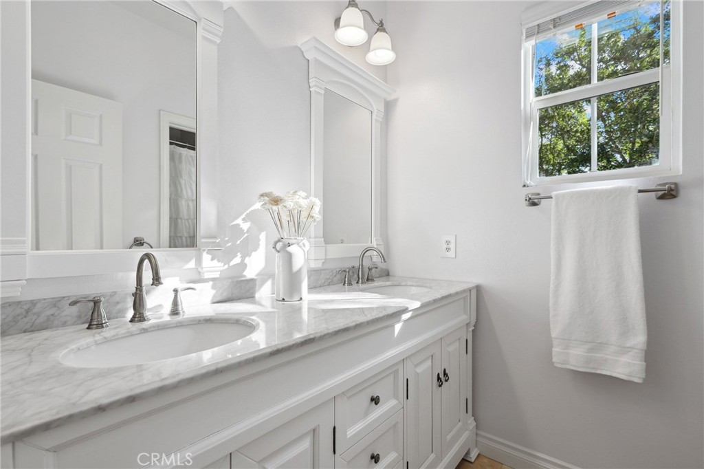 7 Wegeford Circle Ladera Ranch, CA 92694 - Photo 35 of 74 a bathroom with a granite countertop sink and a large mirror