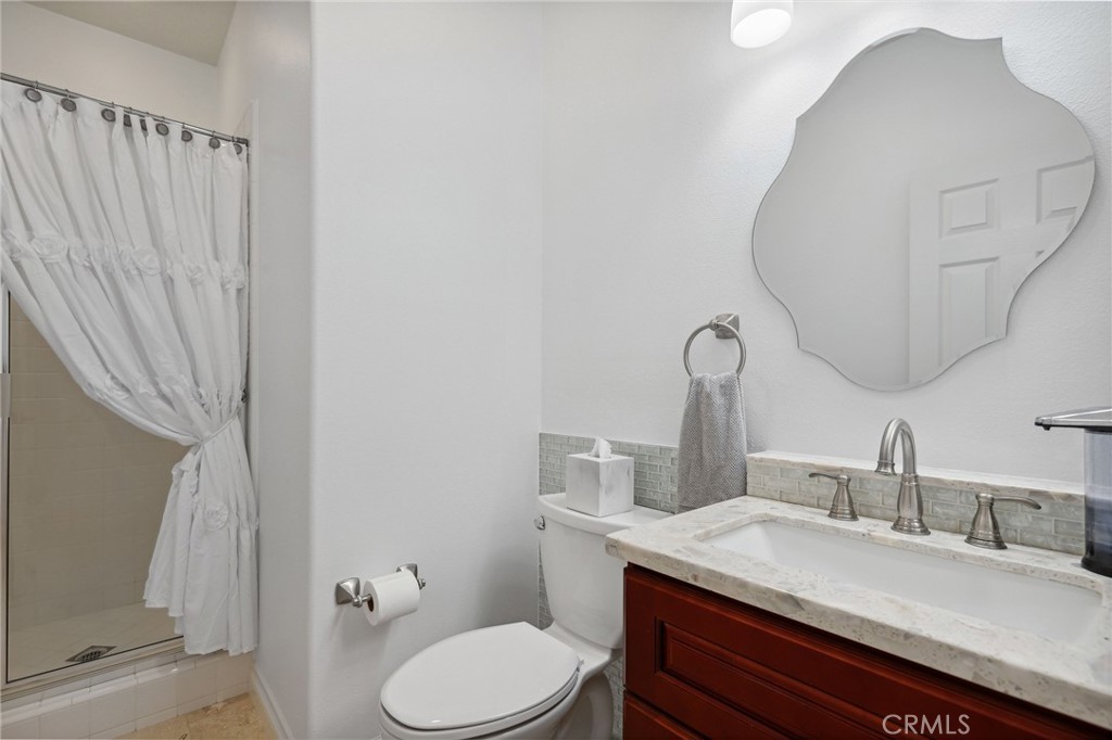 7 Wegeford Circle Ladera Ranch, CA 92694 - Photo 41 of 74 a bathroom with a granite countertop sink mirror vanity and toilet