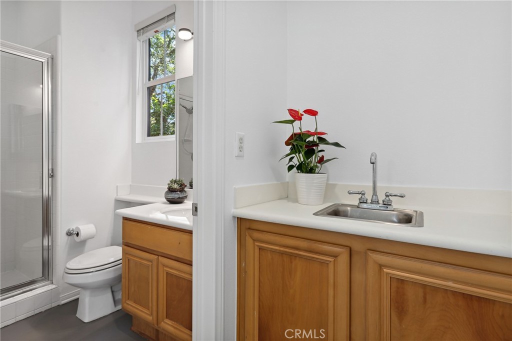 7 Wegeford Circle Ladera Ranch, CA 92694 - Photo 45 of 74 a bathroom with a toilet a sink and a mirror