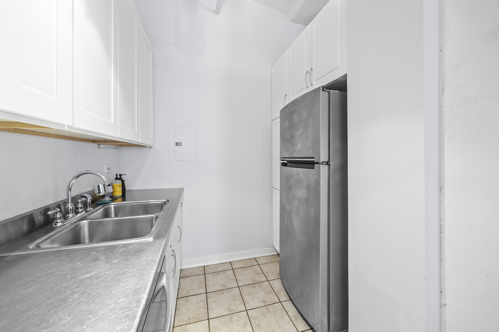 801 South Wells Street, Unit 608 Chicago, IL 60607 - Photo 8 of 17 a kitchen with sink a refrigerator and cabinets