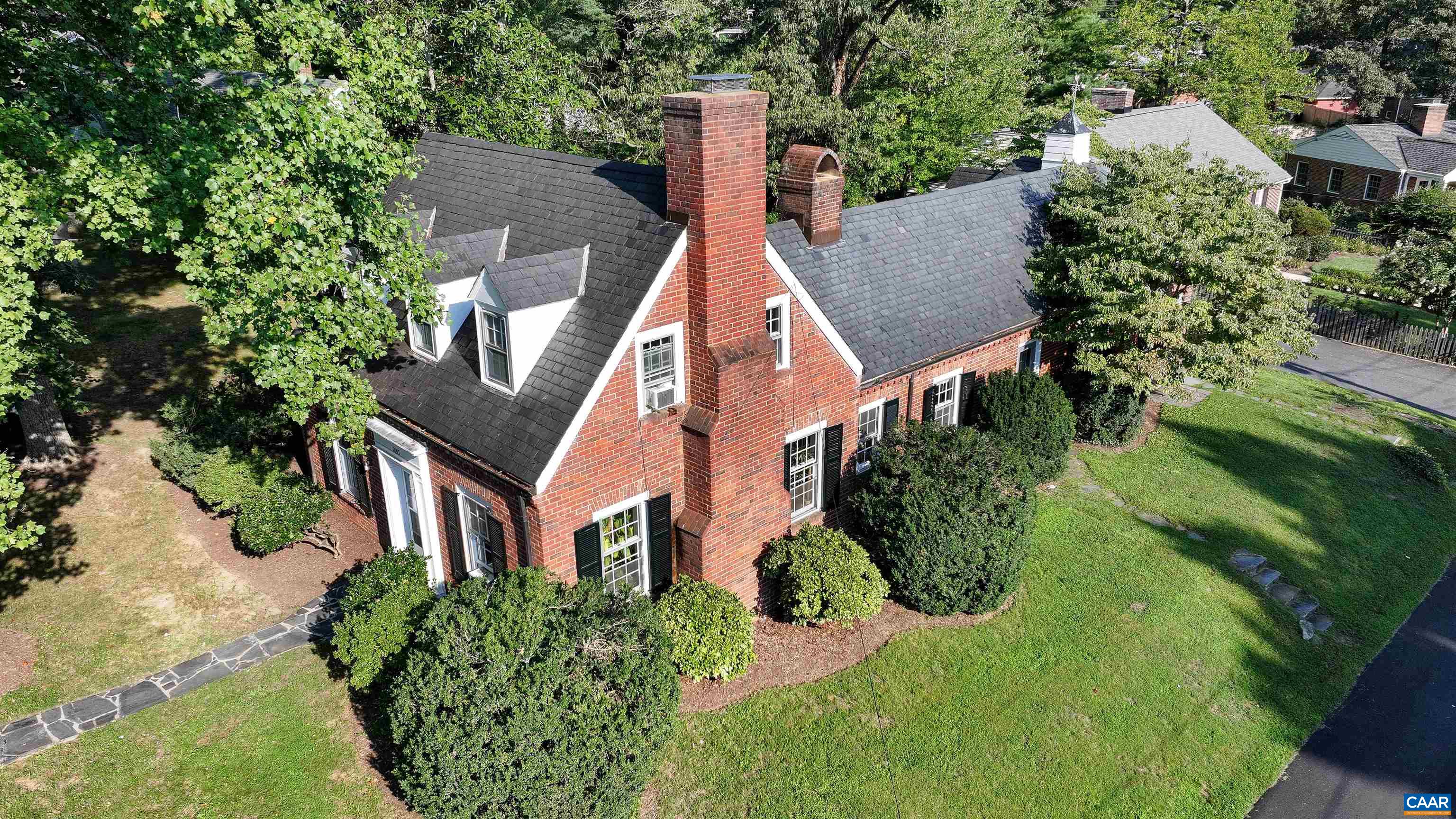 an aerial view of a house with a yard and potted plants