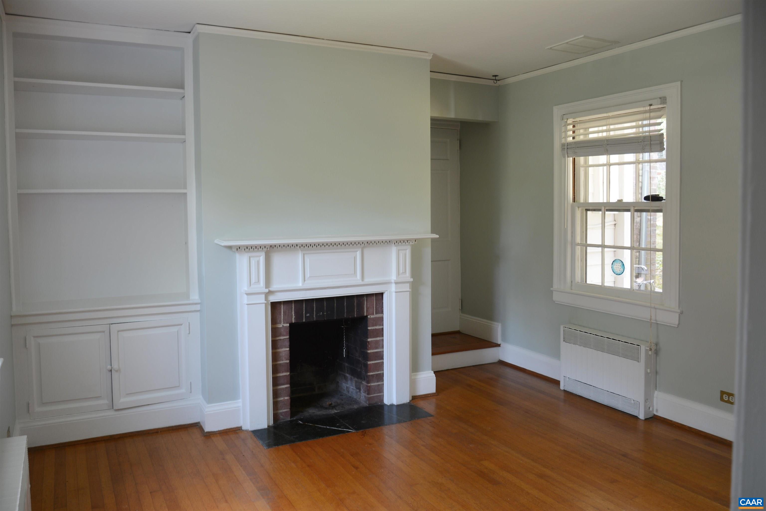 2003 Lewis Mountain Road Charlottesville, VA 22903 - Photo 6 of 19 a view of an empty room with a fireplace and a window
