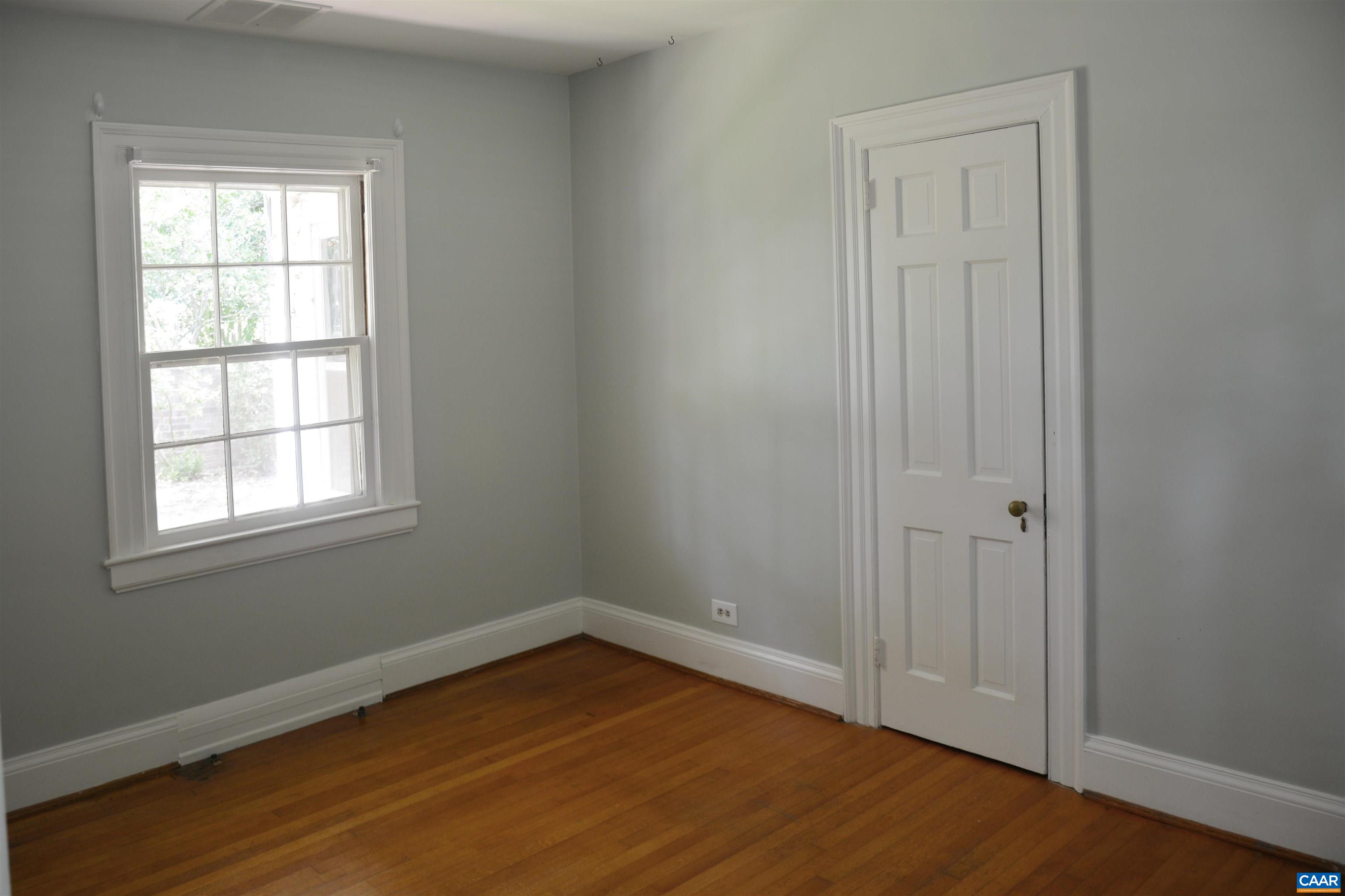 2003 Lewis Mountain Road Charlottesville, VA 22903 - Photo 7 of 19 an empty room with wooden floor and windows