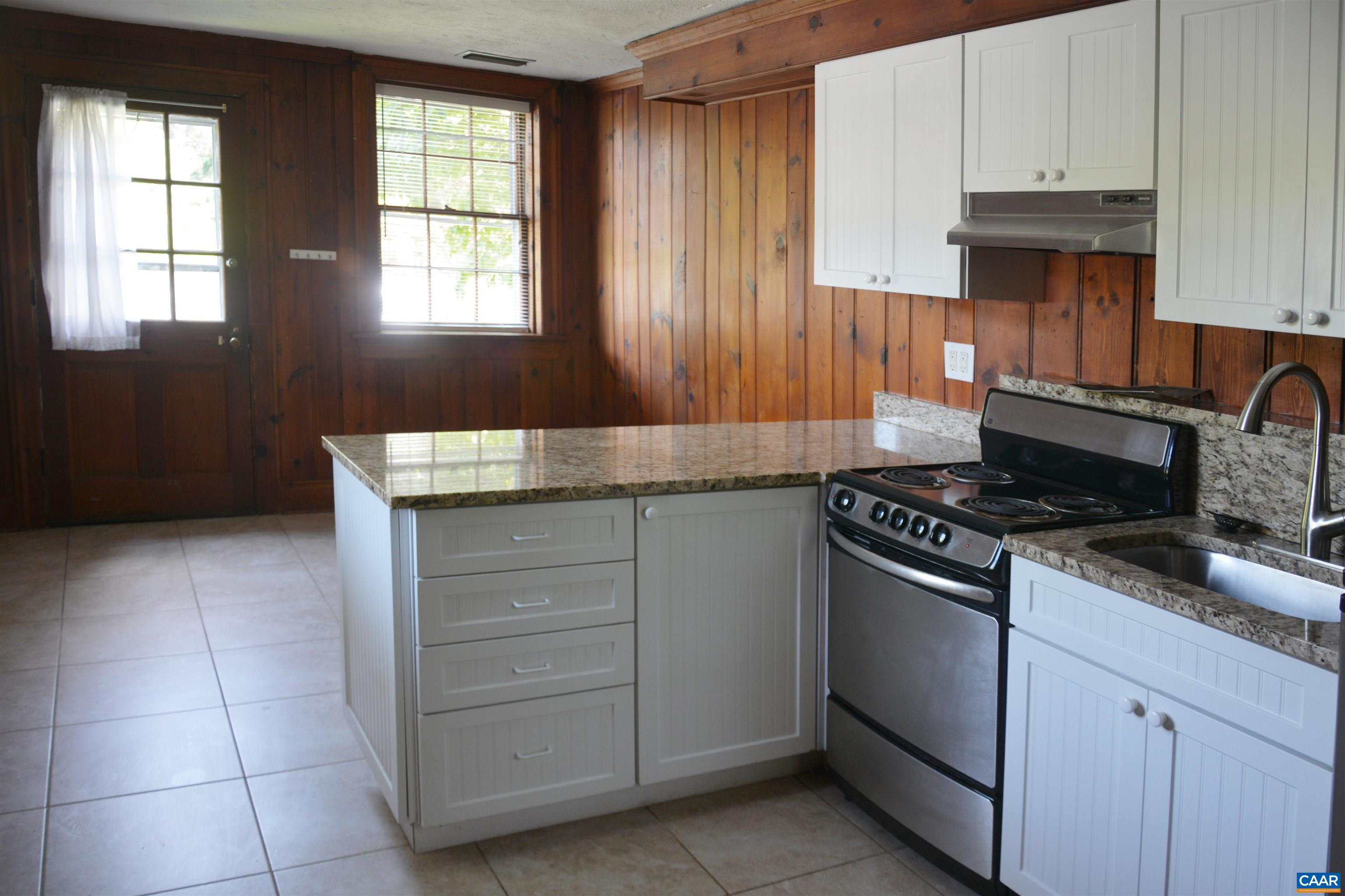 2003 Lewis Mountain Road Charlottesville, VA 22903 - Photo 8 of 19 a kitchen with granite countertop a stove and a sink