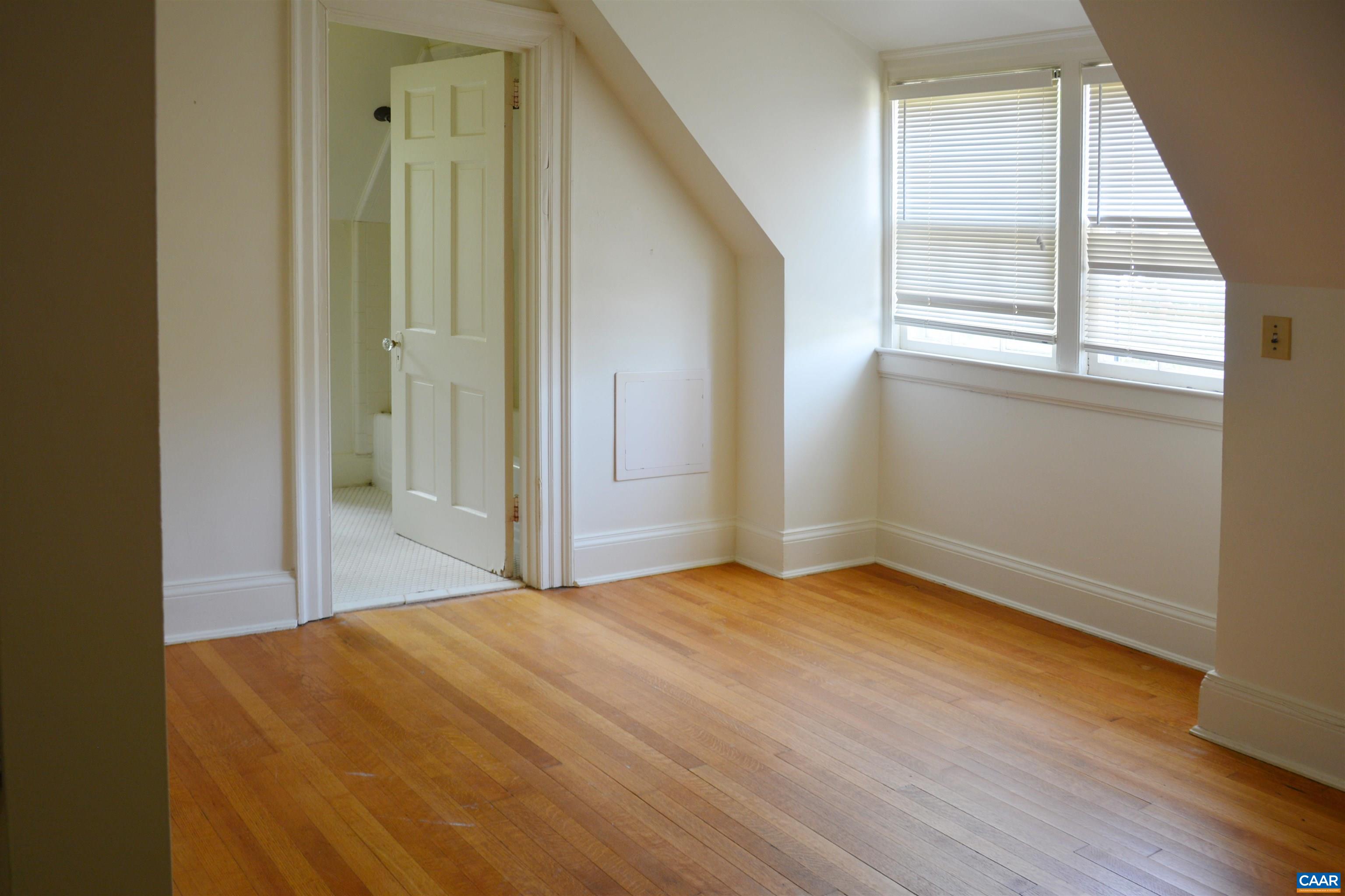 2003 Lewis Mountain Road Charlottesville, VA 22903 - Photo 9 of 19 a view of an empty room with wooden floor and a window