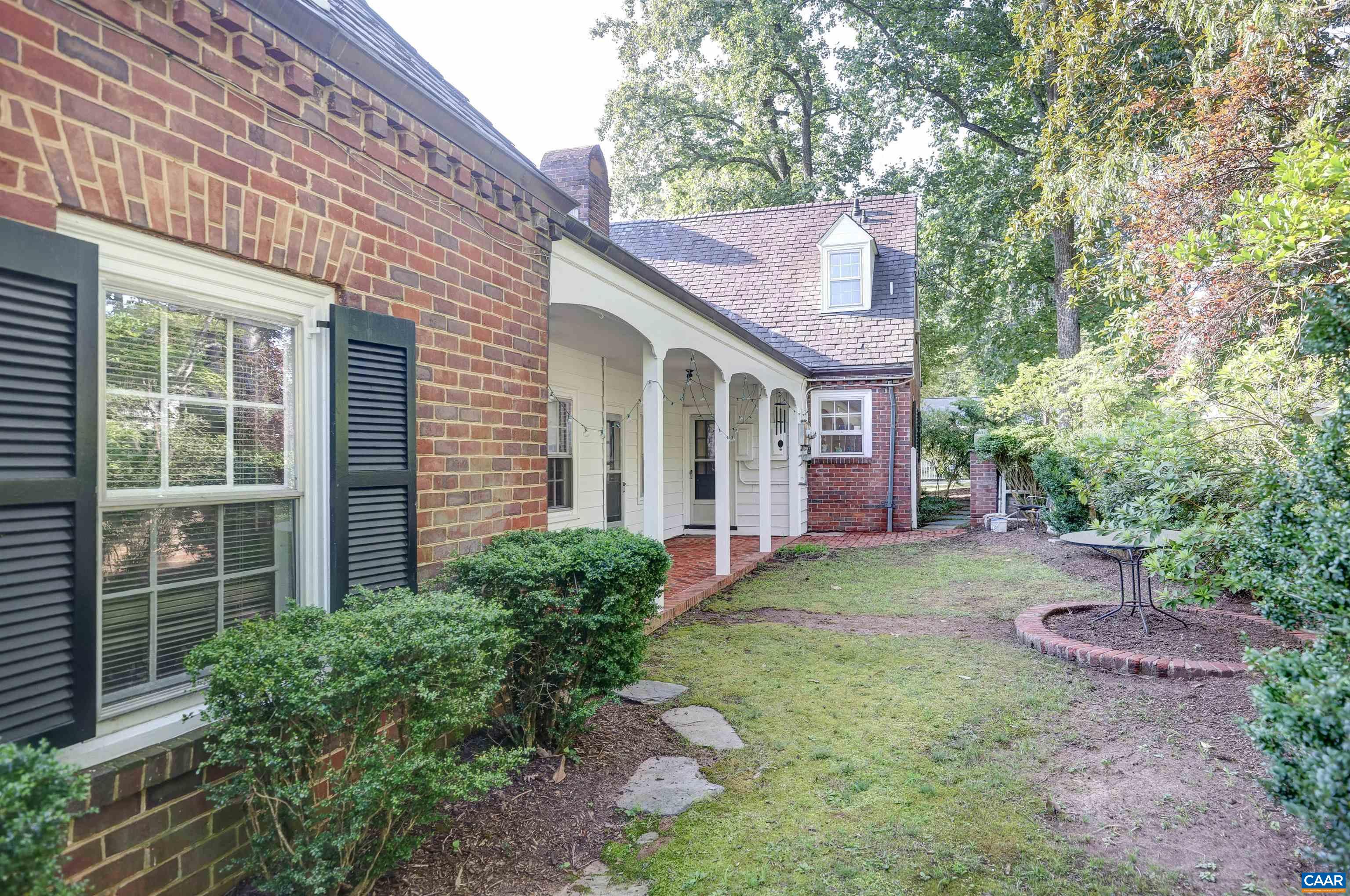 2003 Lewis Mountain Road Charlottesville, VA 22903 - Photo 10 of 19 a view of a brick house with a yard and large tree