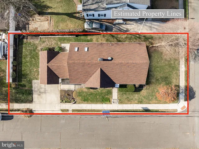 an aerial view of a house with garden space and street view