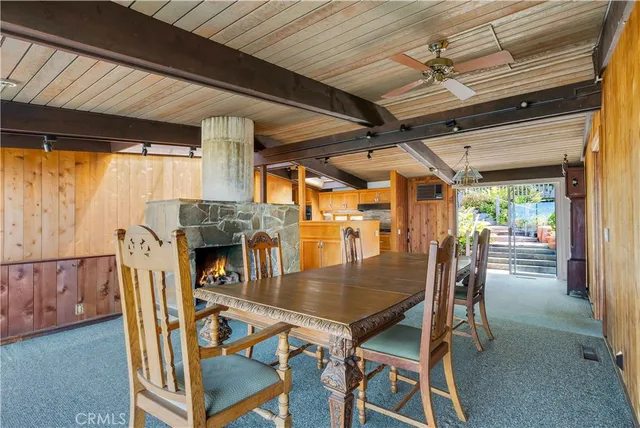 a dining room with furniture fireplace and wooden floor