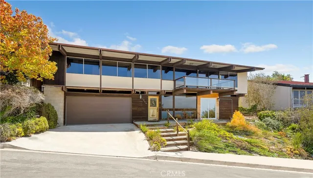 a view of a house with a yard and plants