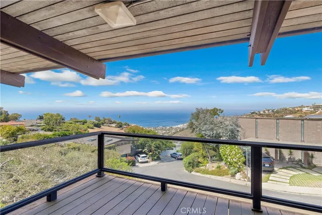 a view of a balcony with wooden chairs