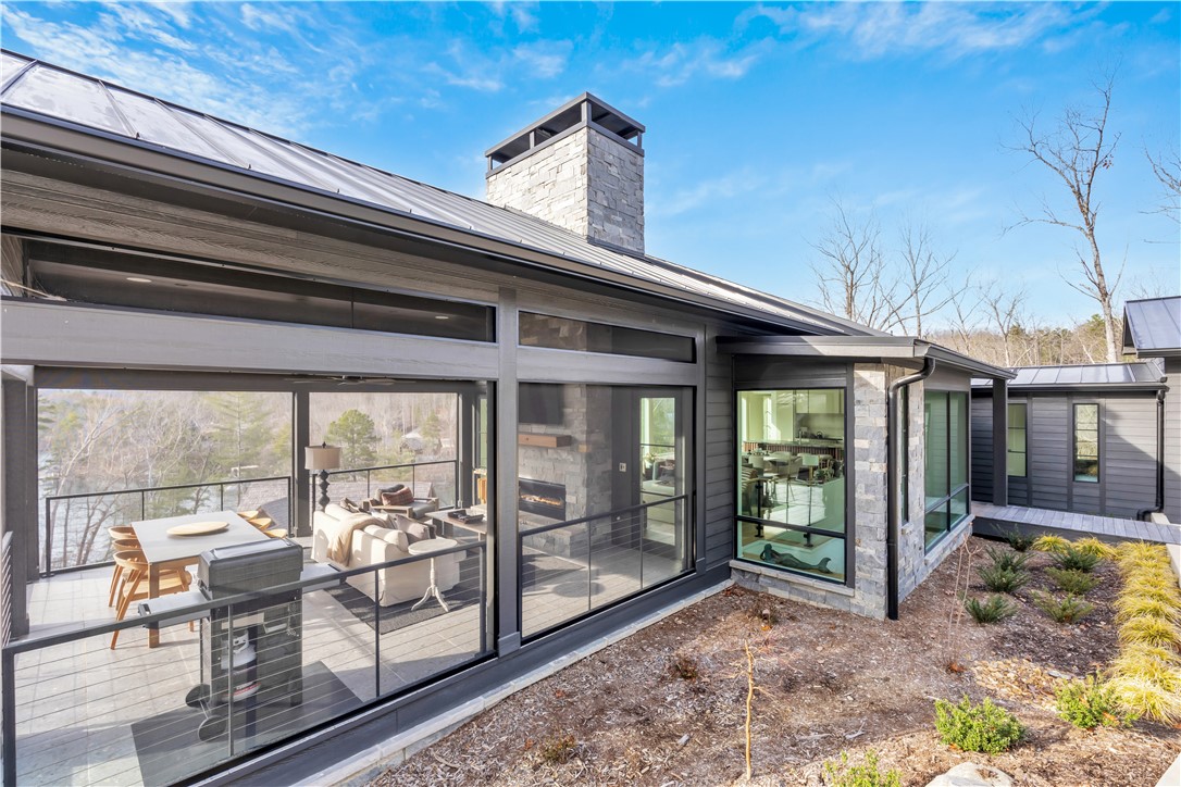 127 Crosswind Court Sunset, SC 29685 - Photo 6 of 49 This modern home features an expansive deck and large windows, offering serene views.