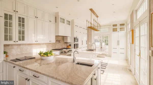 a kitchen with stainless steel appliances granite countertop a sink a stove and a granite counter tops