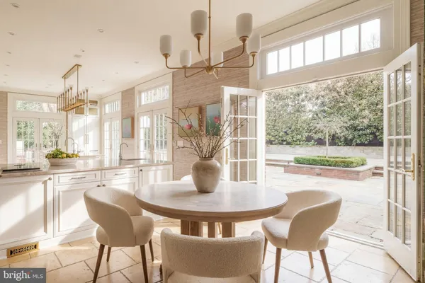 a dining room with furniture and a floor to ceiling window