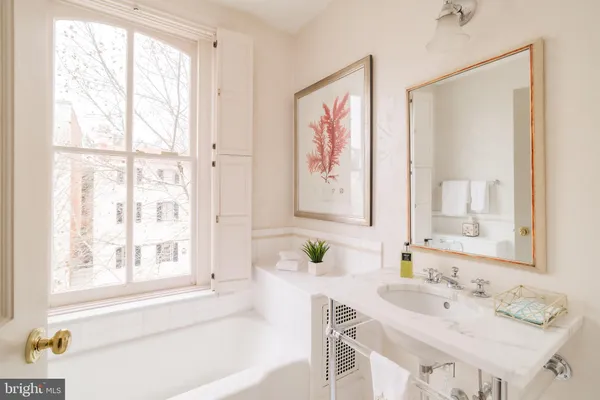 a spacious bedroom with two beds and a window