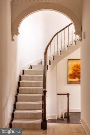 a view of staircase with white walls and a window