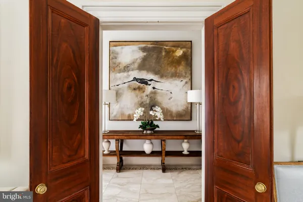 a room with wooden door and furniture