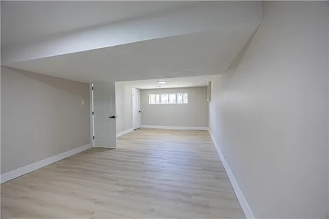 a view of wooden floor and windows in a room