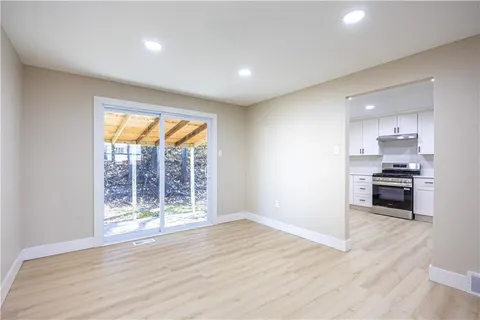 a view of kitchen with wooden floor and electronic appliances