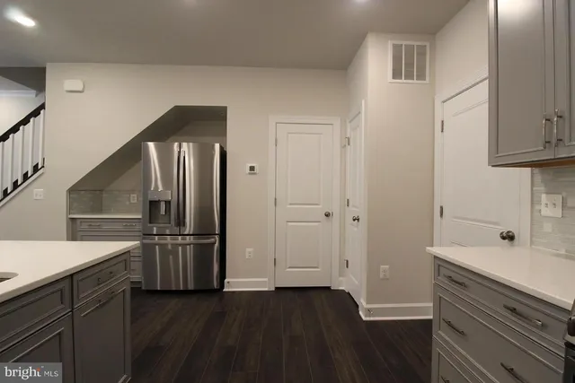 a kitchen with cabinets and stainless steel appliances