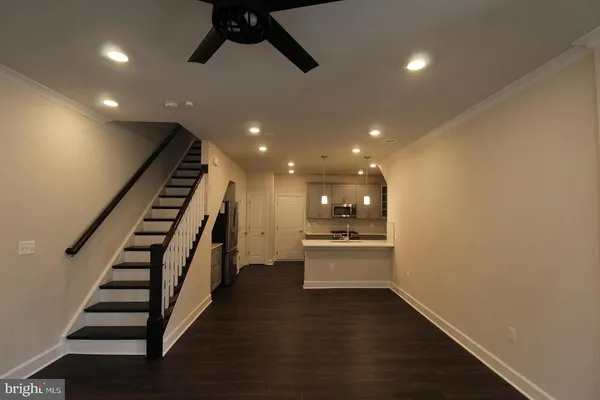 a view of entryway and hall with wooden floor