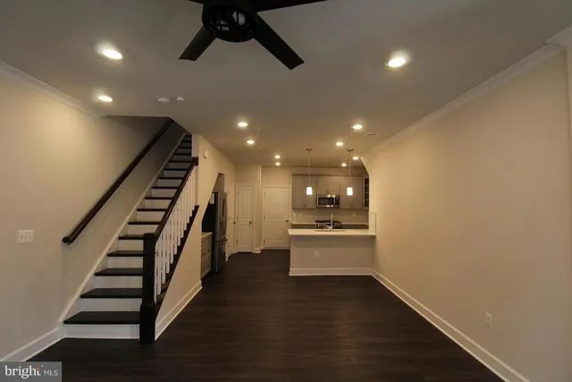 a view of entryway and hall with wooden floor