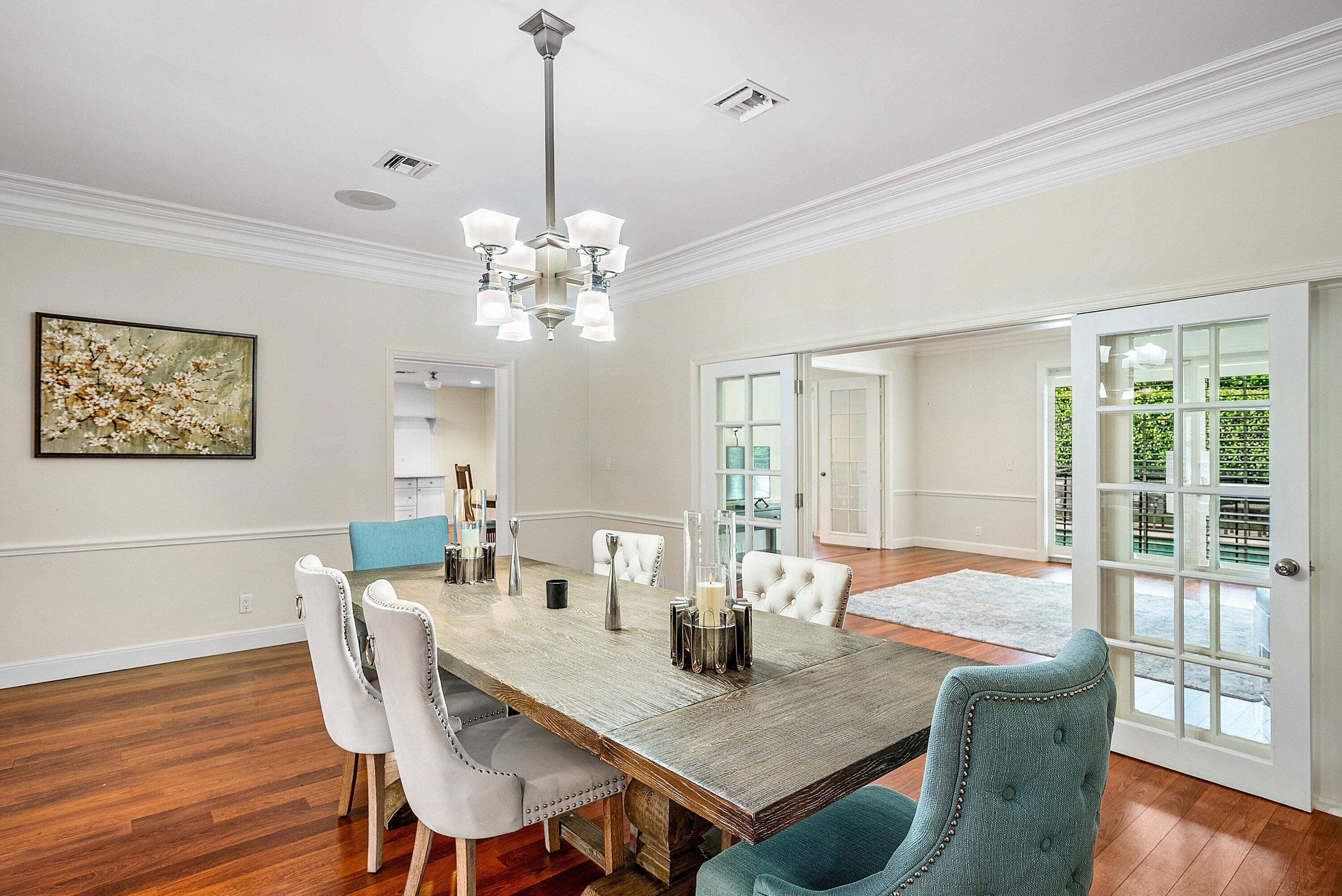 2121 Areca Palm Road Boca Raton, FL 33432 - Photo 12 of 54 a view of a dining room with furniture wooden floor and chandelier