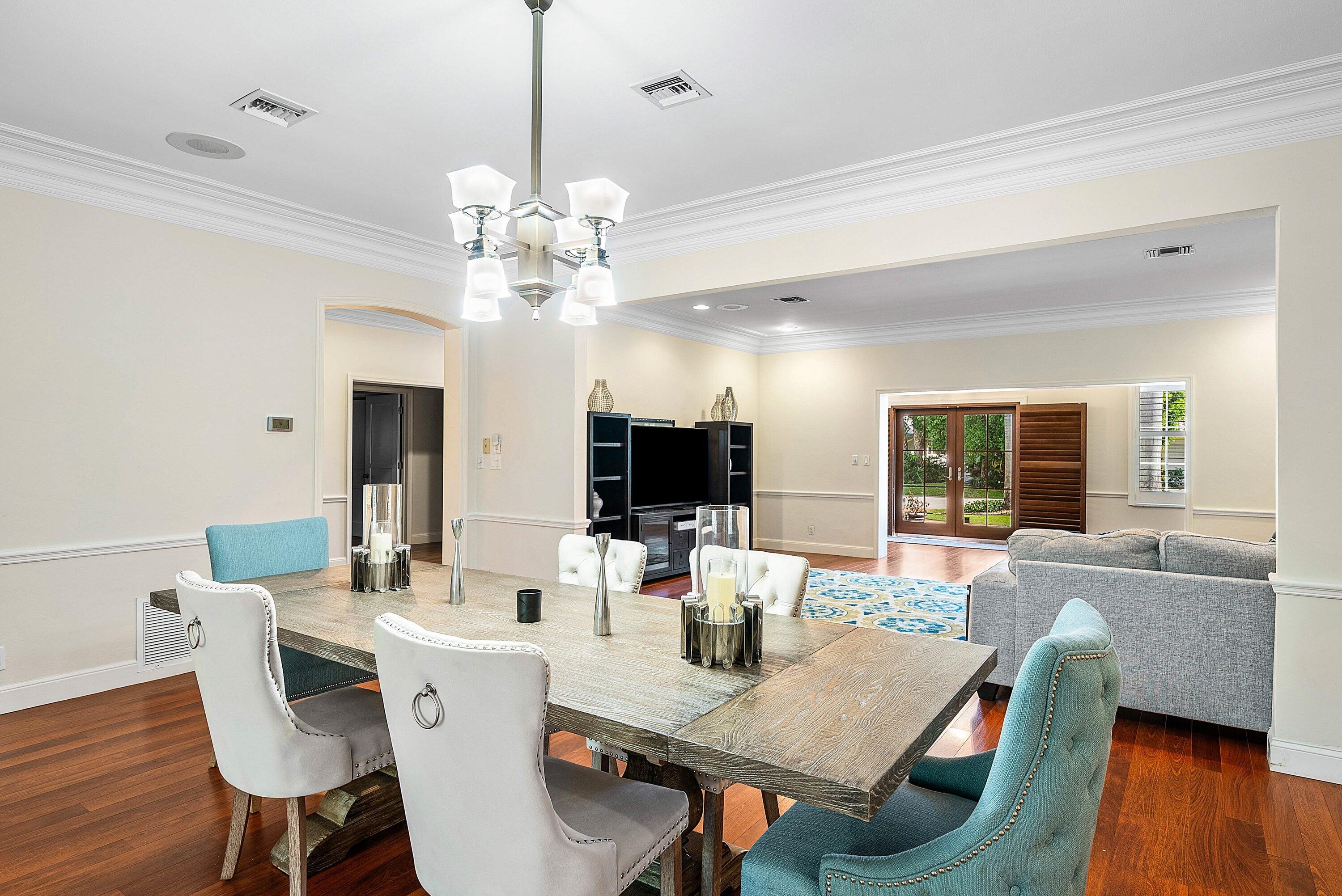 2121 Areca Palm Road Boca Raton, FL 33432 - Photo 13 of 54 a view of a dining room with furniture wooden floor and chandelier