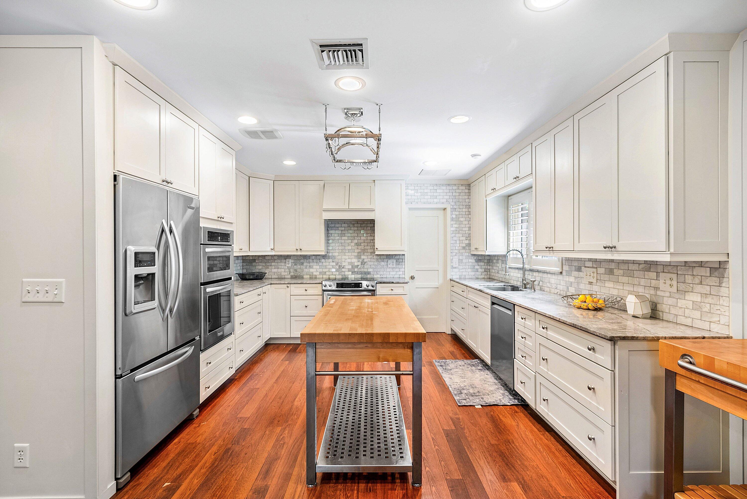 2121 Areca Palm Road Boca Raton, FL 33432 - Photo 22 of 54 a large kitchen with kitchen island a large counter space stainless steel appliances and cabinets