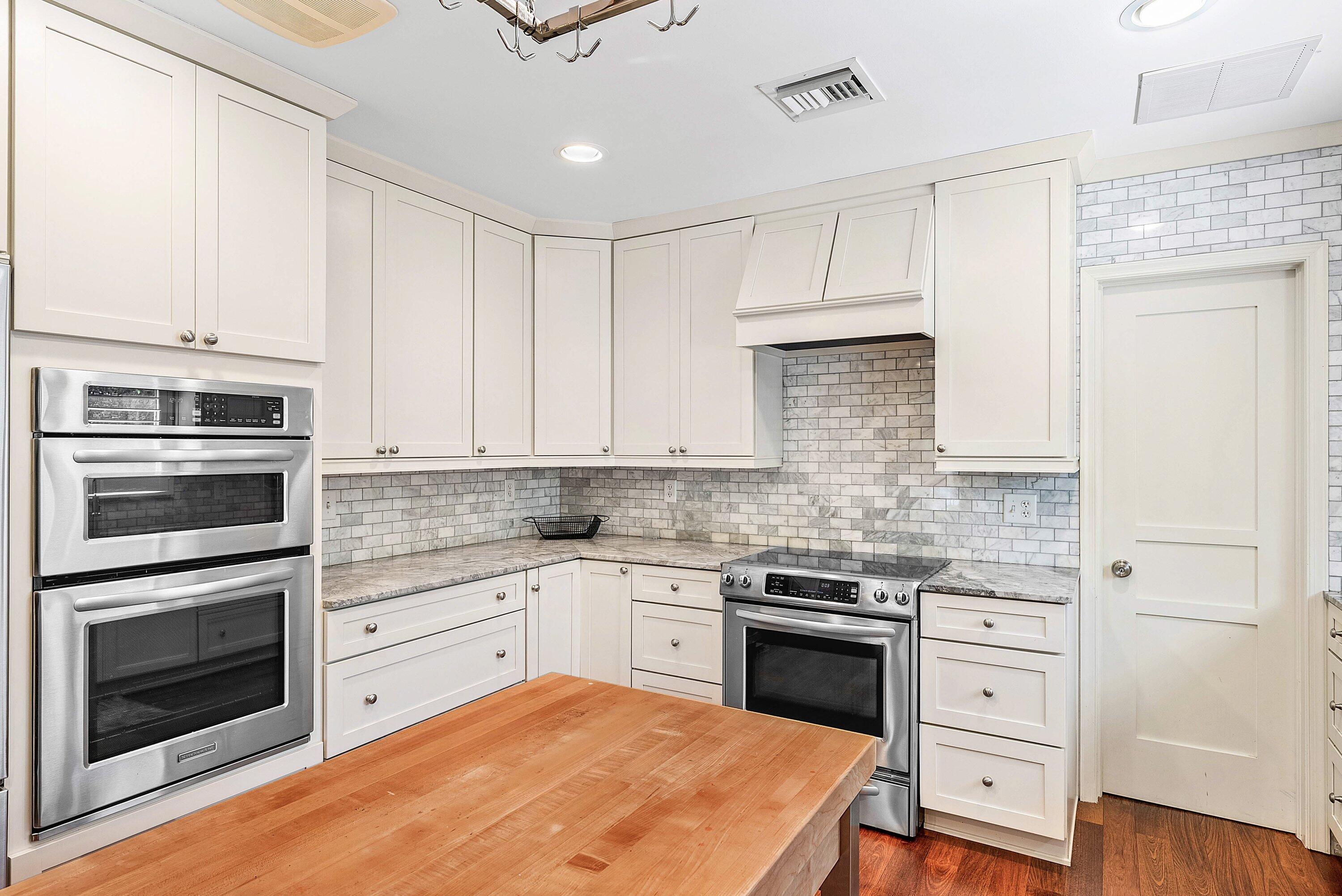 2121 Areca Palm Road Boca Raton, FL 33432 - Photo 23 of 54 a kitchen with stainless steel appliances granite countertop a stove and cabinets