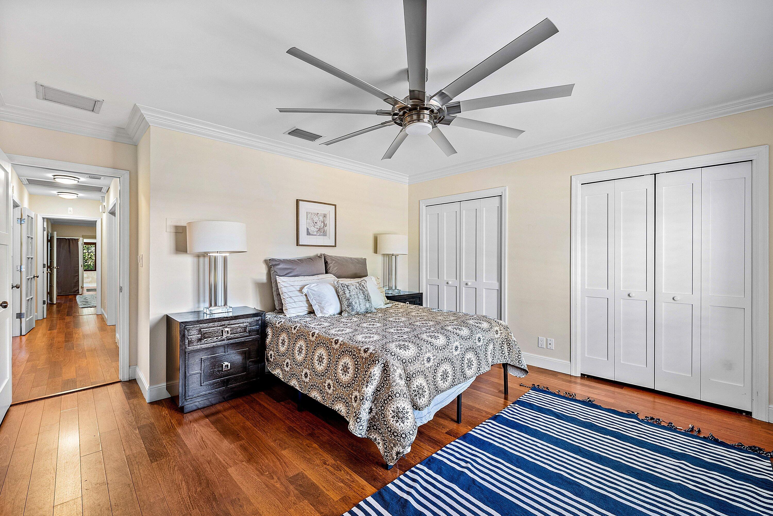 2121 Areca Palm Road Boca Raton, FL 33432 - Photo 28 of 54 a bedroom with a bed and a chandelier