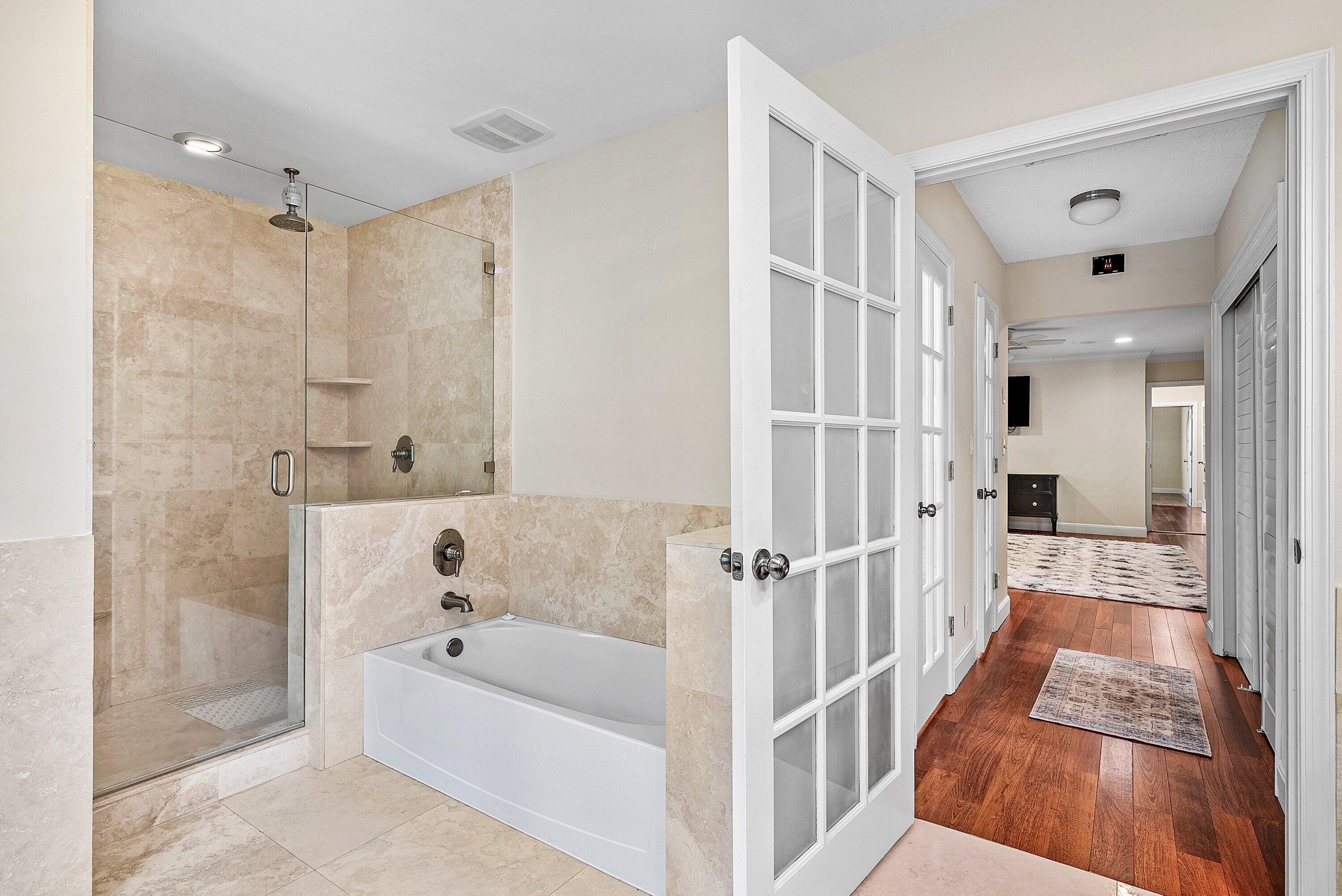 2121 Areca Palm Road Boca Raton, FL 33432 - Photo 38 of 54 a bathroom with a bathtub and a shower