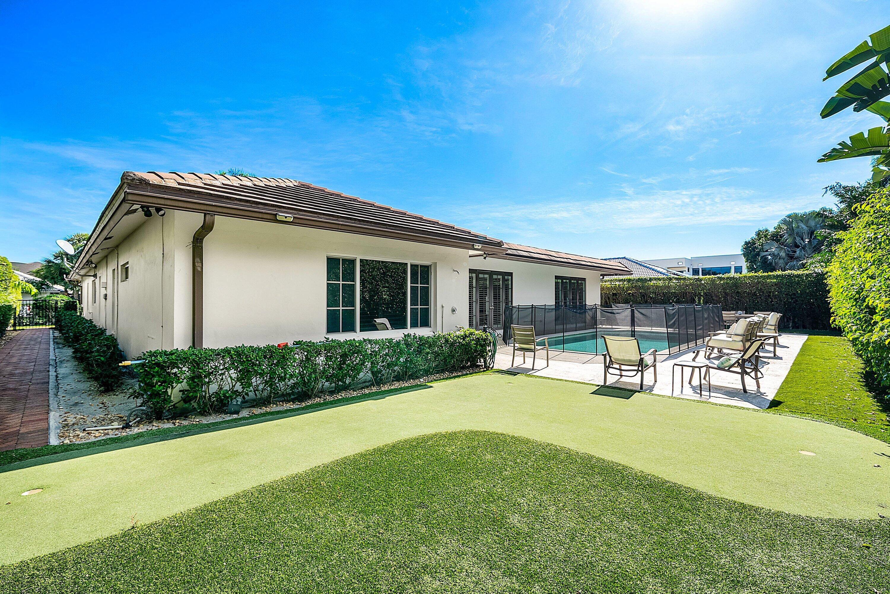 2121 Areca Palm Road Boca Raton, FL 33432 - Photo 39 of 54 a view of a house with swimming pool and sitting area