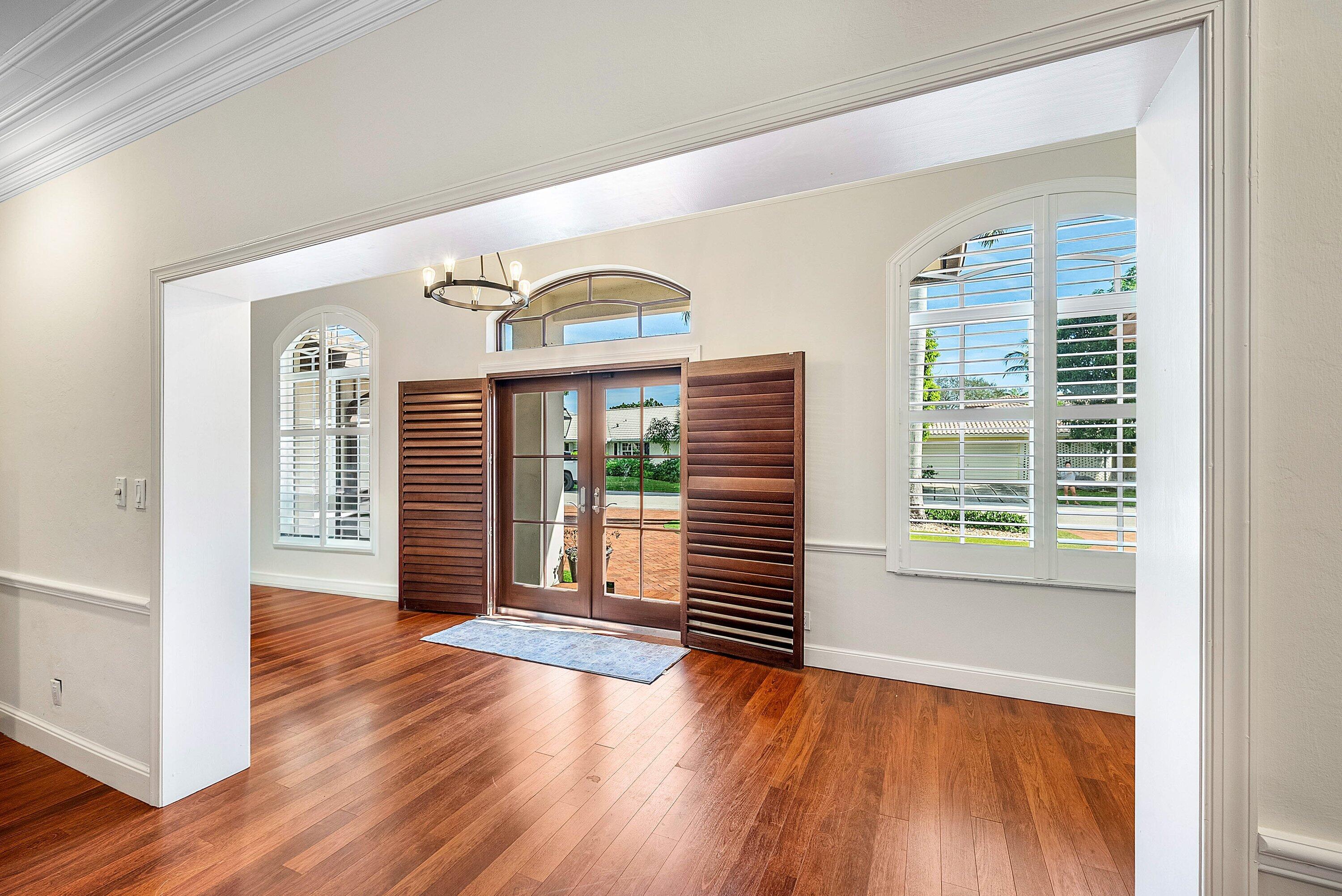 2121 Areca Palm Road Boca Raton, FL 33432 - Photo 7 of 54 a view of a livingroom with wooden floor and a large window