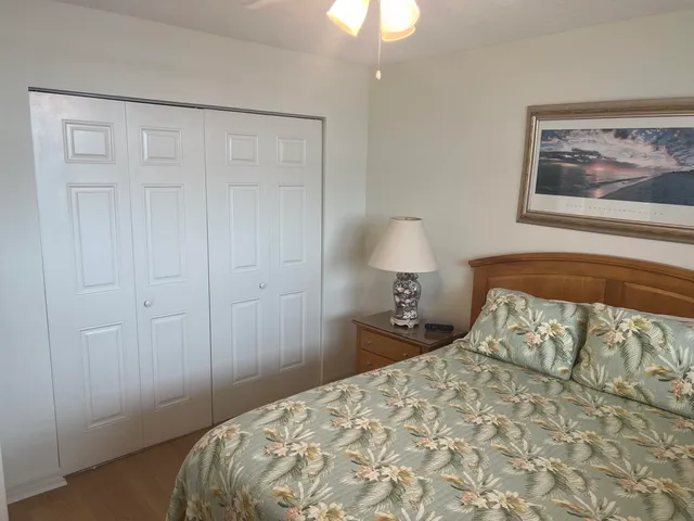 a bedroom with a bed and a painting on the wall