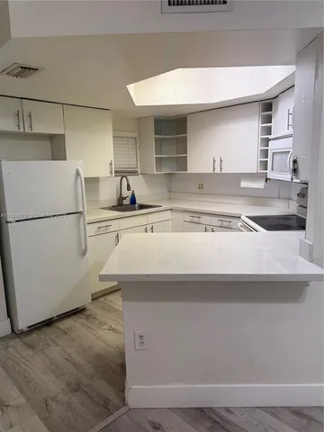 a kitchen with appliances and cabinets