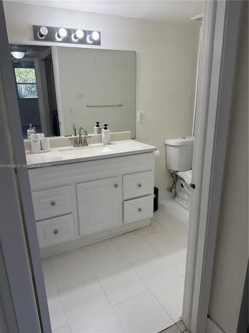 a bathroom with a sink vanity and mirror
